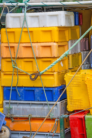 empty boxes for fish on a trawlerの写真素材