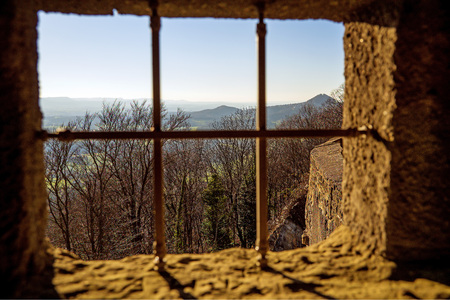medieval window of a castle with view to German mountainsの写真素材