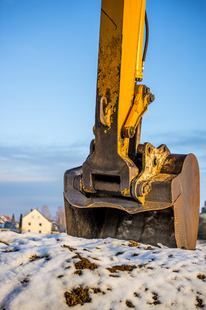 Excavator bucket in snowの写真素材