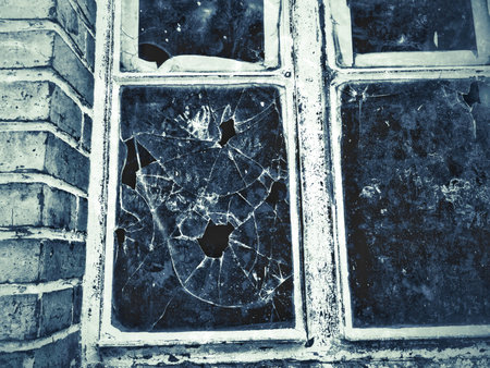 old window of a factory with broken glass in retro styleの写真素材