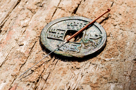 acupuncture needle on chinese coinの写真素材