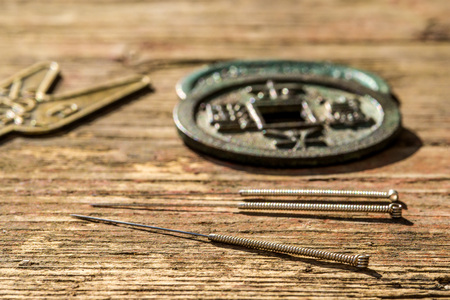 acupuncture needles on Chinese coinの写真素材