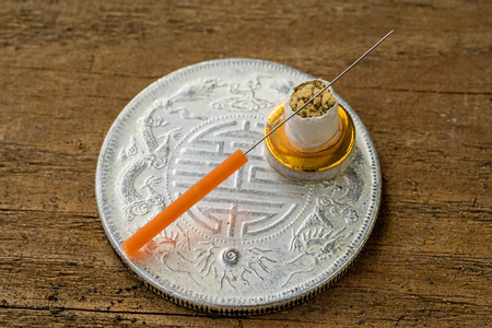 acupuncture needle on chinese coinの写真素材