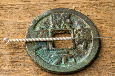 acupuncture needle on chinese coinの写真素材