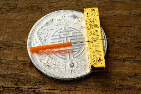 acupuncture needle on chinese coinの写真素材