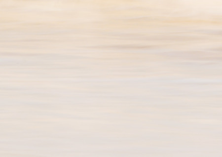 Background of blurred surf with sandの写真素材