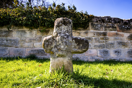 penitence cross with old medieval abbey wallの写真素材