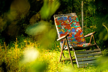 deck chair in a private garden hidden behind greenの写真素材
