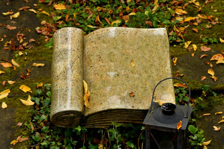 tombstone in shape of a book in a graveyardの写真素材