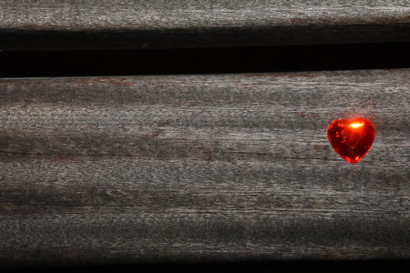 Heart on a plank of a park benchの写真素材