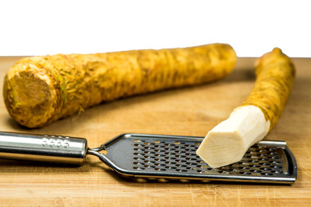 horseradish, whole piece and peeled piece on graterの写真素材