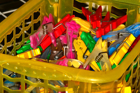 colorful clothespins in a basket in a closeupの写真素材
