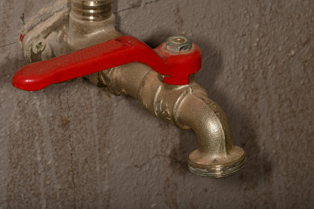 old water tap in a cellarの写真素材