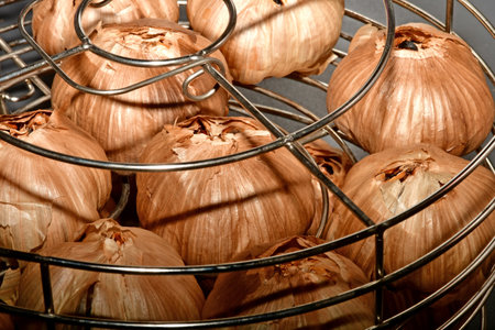 black fermented garlic in a grid basketの写真素材