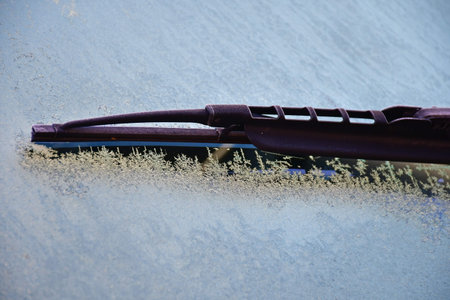car with frozen window and windshield wipers in winterの写真素材