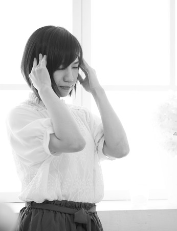 Close up Portrait of woman with headacheの写真素材