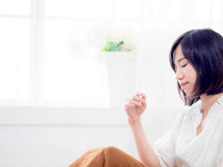 Tormented woman in bedroomの写真素材