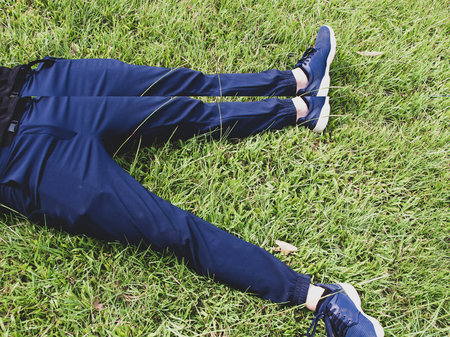 Man laying down on grass relaxing taking it easy
