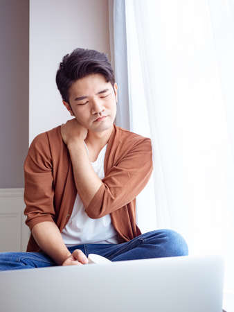 Asian man having a shoulder painの写真素材