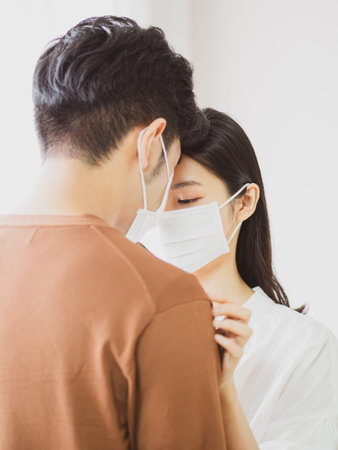 asian woman and man wearing Surgical mask at home