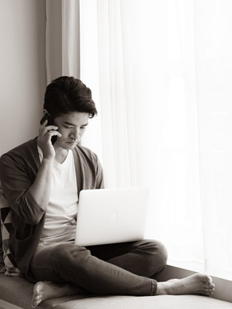 Young man wearing casual clothes and talking on mobile phone