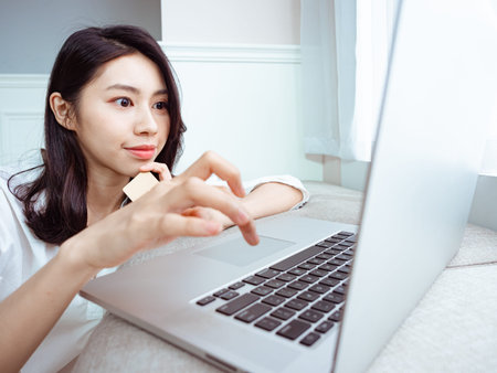 Young woman shopping online with credit card and laptop at home