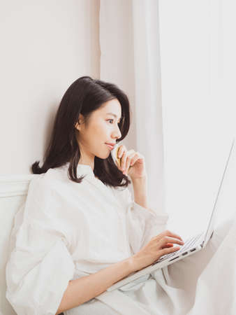 Young asian beauty shopping online with credit card and laptopの写真素材