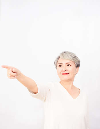 Senior asian woman pointing up 1 finger in white background.の写真素材