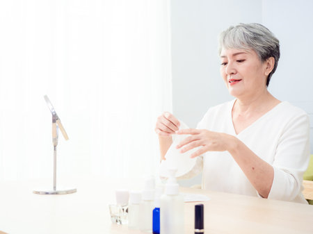 closeup senior asian woman's face and facial maskの写真素材