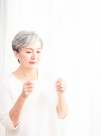Senior asian woman wearing facemask during  flu outbreak.の写真素材
