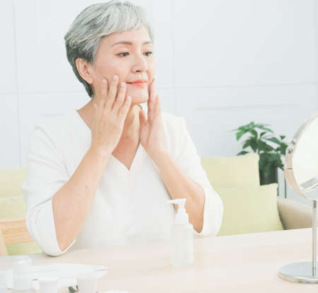 Senior asian woman who skin care at home.の写真素材