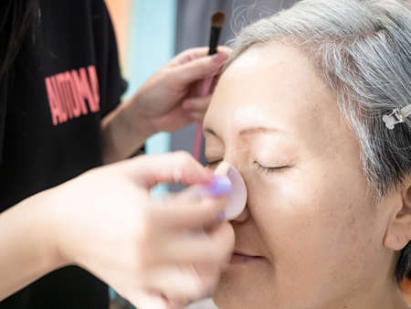 Senior asian woman and make up artist.の写真素材