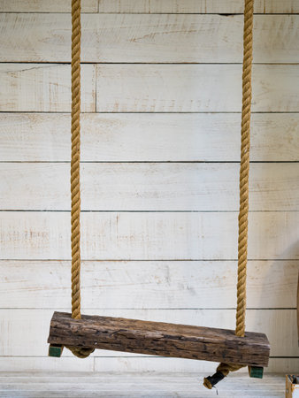 swing in white wooden background.