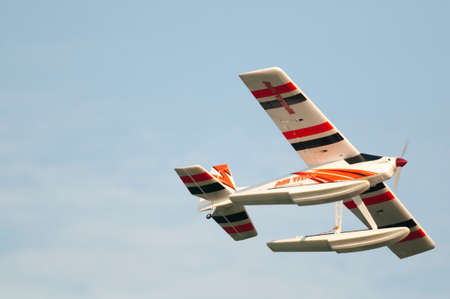 Radio controlled float plane. Close-up flying overhead.のeditorial素材