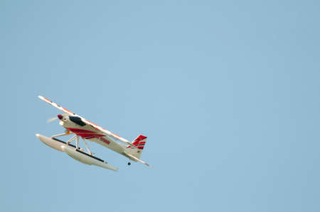 Radio controlled float plane in a banked right turn.のeditorial素材