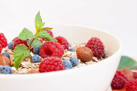 Oat nuts with fresh blueberries and raspberries and hazelnuts