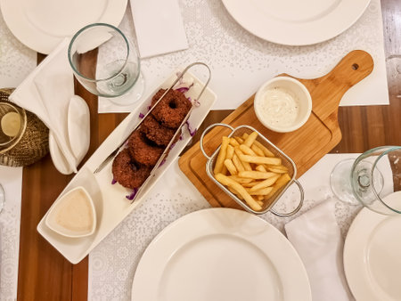 Arabic and Lebanese cuisine meat appetizer kibbeh, falafil on a plate with fries. Horizontal view from aboveの写真素材