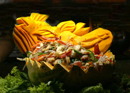 A hand-carved melon bowl of saladの写真素材