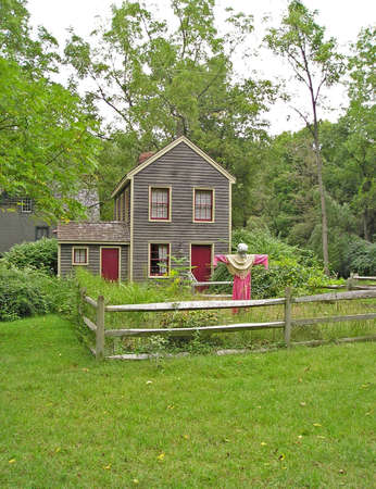 A colonial house with a scarecrowの写真素材