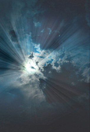 Sunburst coming through a cloudy skyの写真素材