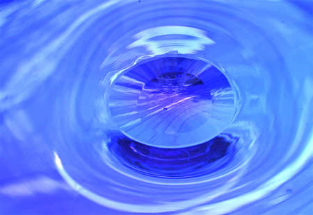 looking througha blue glass bowlの写真素材