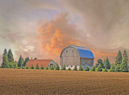 An incoming strom and a barn and field        の写真素材