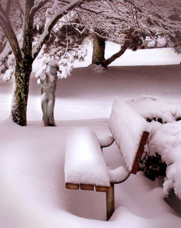 asoft, tinted bench and statue in snowの写真素材