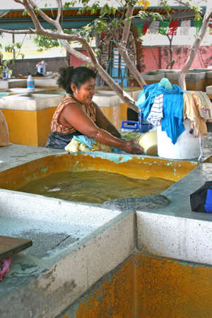 Mexican women doing hand washing in sinks in Alcapulco, Mexicoの写真素材