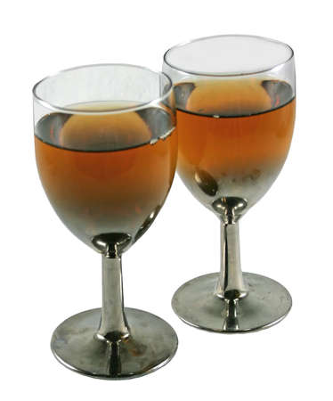 two glasses filled with brandy wine on isolated backgroundの写真素材
