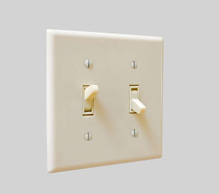 a double-toggle light switch on an isolated backgroundの写真素材
