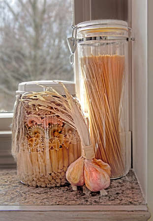 a variety of pastas and paper garlic in windowの写真素材
