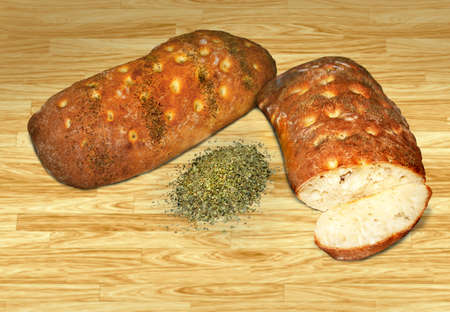 loaves of homemade chiabatta  artisan bread with italian herbsの写真素材