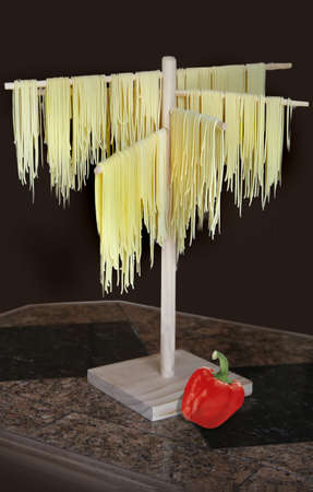 homemade spaghetti on a drying rackの写真素材