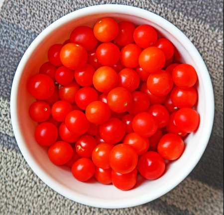 a bowl full of cherry tomatoesの写真素材
